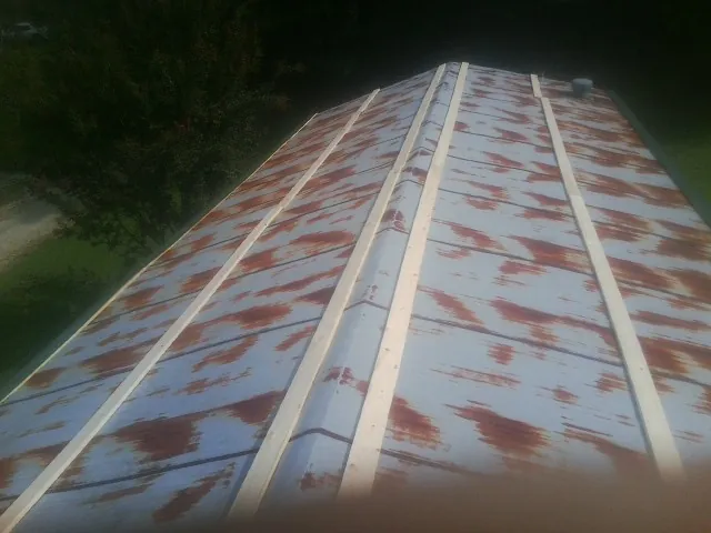 Rusted metal roof panels with new wood purlins before replacement — Storm Damage Roof Repair in Tioga by Roofing Brothers