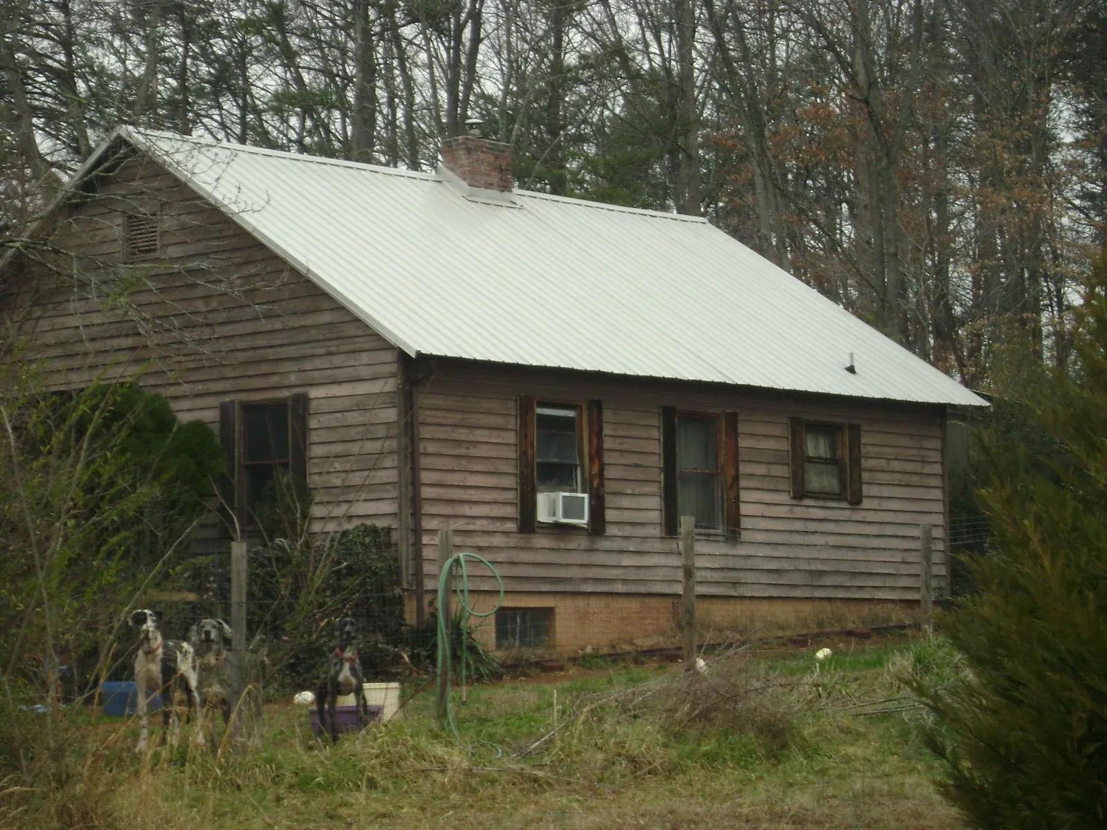 White metal roof on an old wood sided farmhouse, from a Metal Roof Installation job in Tioga